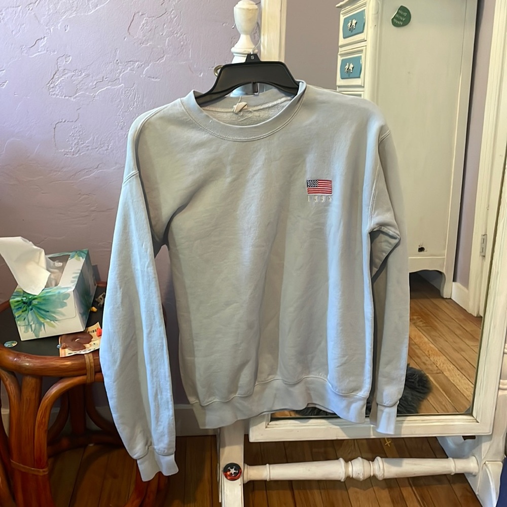 Small blue crewneck sweater.